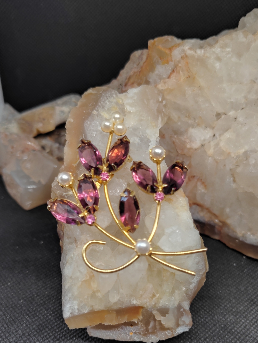 Vintage Gold-Tone Floral Spray Brooch with Purple Prongset Rhinestones.
